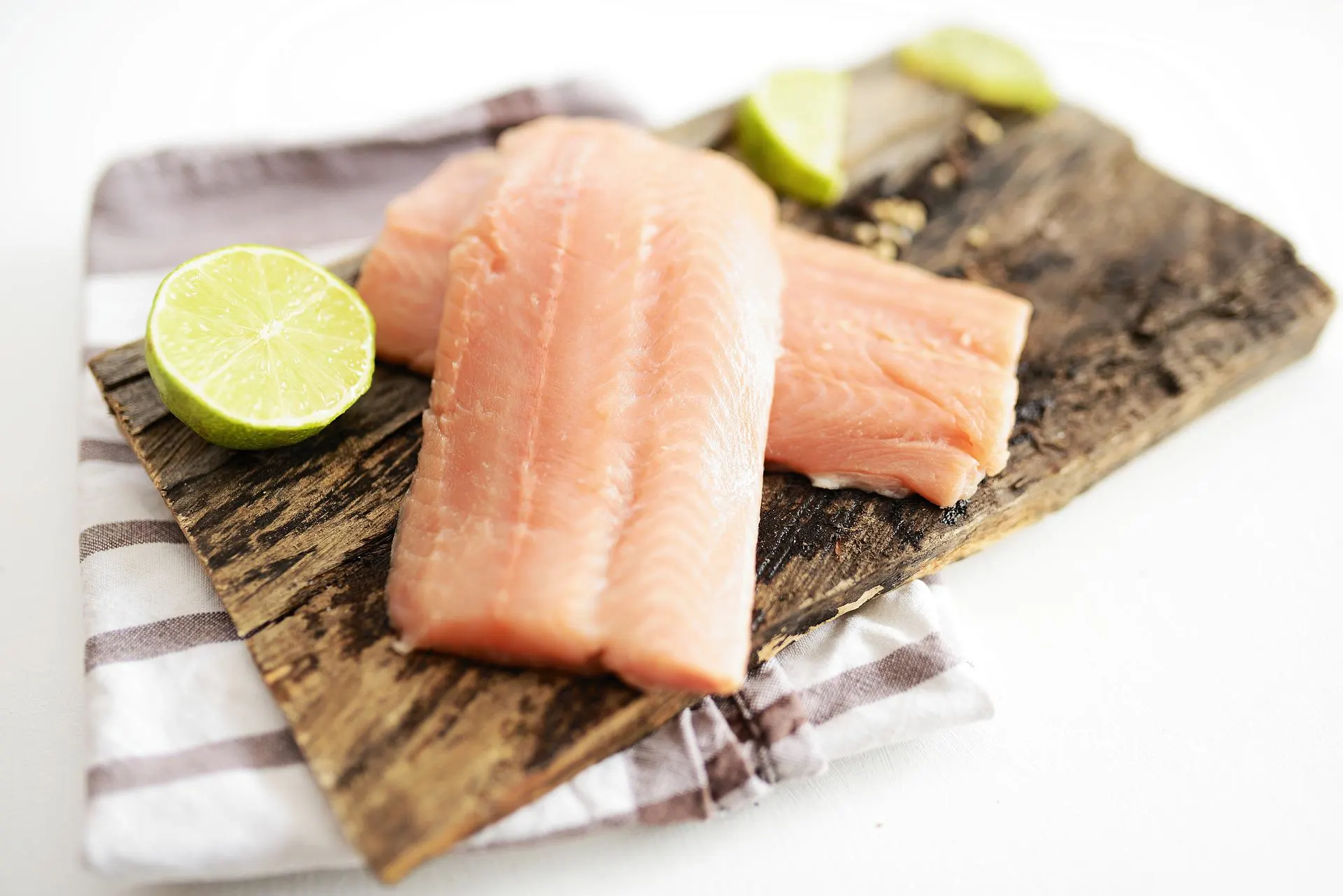 wild salmon with lime on a wood platter